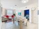 Bright dining room with modern furnishings, open floor plan to adjacent living space and bedroom at 2809 Almaton Loop # 304, Kissimmee, FL 34747