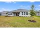 Spacious backyard with grassy lawn and covered patio at 2944 Arranmore Dr, Ormond Beach, FL 32174