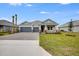 Two-story house with gray siding, red door, and a two-car garage at 2944 Arranmore Dr, Ormond Beach, FL 32174