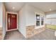 Front entrance with red door and stone accents at 2944 Arranmore Dr, Ormond Beach, FL 32174