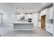 Modern kitchen with white cabinets, stainless steel appliances, and large island at 2944 Arranmore Dr, Ormond Beach, FL 32174
