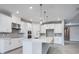 Modern kitchen with white cabinets and a large island at 2944 Arranmore Dr, Ormond Beach, FL 32174