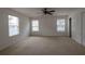 Large bedroom with ceiling fan and neutral carpeting at 1513 Blue Sky Way, Clermont, FL 34714