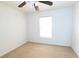 Well-lit bedroom featuring a window and ceiling fan at 1513 Blue Sky Way, Clermont, FL 34714