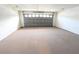 Spacious garage with double door and carpeted floor at 1513 Blue Sky Way, Clermont, FL 34714