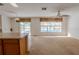 Bright Gathering room features carpeting, ceiling fan, and view of the pool at 1513 Blue Sky Way, Clermont, FL 34714