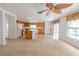 Kitchen boasts wood cabinets, an island, and tile flooring at 1513 Blue Sky Way, Clermont, FL 34714