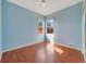 Light-filled bedroom with wood floors, ceiling fan, and serene blue walls at 2686 Maxwell W Ct, Kissimmee, FL 34743