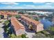 Beautiful aerial view of a condo community featuring lush landscaping and a serene pond at 6107 Metrowest Blvd # 104, Orlando, FL 32835