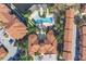 Aerial view displays community pool, palm trees, red umbrellas, surrounded by lush landscaping and condo buildings at 6107 Metrowest Blvd # 104, Orlando, FL 32835