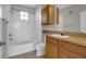 Cozy bathroom featuring a tub/shower combo, a single sink vanity, and tiled flooring at 6107 Metrowest Blvd # 104, Orlando, FL 32835