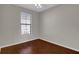 Empty bedroom featuring hardwood floors and a window at 6107 Metrowest Blvd # 104, Orlando, FL 32835