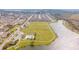 Expansive aerial view of a community with a pool, playground, field, and pond, creating a vibrant and active lifestyle at 1511 Alligator St, St Cloud, FL 34771