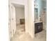 A bathroom featuring a vanity with dark cabinets, a shower with patterned curtains, and tiled flooring at 1511 Alligator St, St Cloud, FL 34771