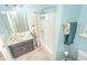 Inviting bathroom with light blue walls, featuring a combined tub and shower with updated fixtures and accessories at 1511 Alligator St, St Cloud, FL 34771