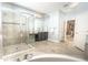 Stylish bathroom featuring a glass-enclosed shower, soaking tub, and dual vanity sinks at 1511 Alligator St, St Cloud, FL 34771