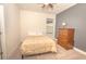 Cozy bedroom with neutral tones, a comfortable bed, and a classic wooden dresser for ample storage at 1511 Alligator St, St Cloud, FL 34771