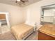 Clean bedroom with a ceiling fan, comfortable bed, natural light, and a dresser for storage at 1511 Alligator St, St Cloud, FL 34771