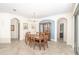 Elegant dining room featuring tile flooring and arched entryways, complemented by stylish furniture and natural light at 1511 Alligator St, St Cloud, FL 34771