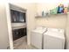 Functional laundry room with modern appliances and storage cabinets and shelving for supplies at 1511 Alligator St, St Cloud, FL 34771