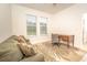Inviting living room features a comfortable couch, stylish rug, and a functional workspace with natural light at 1511 Alligator St, St Cloud, FL 34771