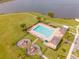 Overhead view featuring a community pool and play area by the lake, perfect for Gathering fun and community engagement at 1511 Alligator St, St Cloud, FL 34771