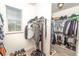Organized walk-in closet featuring ample hanging space, shelving, and natural light from a window at 1511 Alligator St, St Cloud, FL 34771
