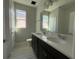 The bathroom features a double vanity with quartz countertop, dark cabinets, and a separate toilet room at 5286 Teirgarten St, Saint Cloud, FL 34771