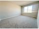 Spacious bedroom features neutral carpet, a large window for natural light, and blank walls at 5286 Teirgarten St, Saint Cloud, FL 34771