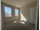 Cozy bedroom featuring soft carpet, neutral walls, a door to the hall, and two large windows for ample light at 5304 Teirgarten St, Saint Cloud, FL 34771