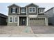 Two story home featuring a two car garage, neutral paint scheme, and a brick driveway at 5304 Teirgarten St, Saint Cloud, FL 34771