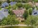 Aerial view of a two-story house with a brown roof and a yellow exterior at 9668 Loblolly Pine Cir, Orlando, FL 32827