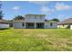 Expansive backyard showcasing a well-maintained lawn, patio, and a two-story home at 1147 Degraw Dr, Apopka, FL 32712