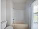 Clean bathroom features a tub/shower combination and window with blinds at 1147 Degraw Dr, Apopka, FL 32712