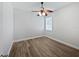 Bedroom has wood flooring, ceiling fan, and natural light from the window at 1147 Degraw Dr, Apopka, FL 32712