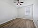 Bedroom with window, wood-look flooring, and ceiling fan at 1147 Degraw Dr, Apopka, FL 32712