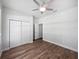 Bright bedroom featuring wood floors, a ceiling fan, and a closet with double doors at 1147 Degraw Dr, Apopka, FL 32712