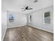 Light-filled bedroom boasting a ceiling fan and wood-style floors for a clean, modern look at 1147 Degraw Dr, Apopka, FL 32712