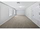 Large bonus room with carpet floors, neutral paint, two windows and two doors at 1147 Degraw Dr, Apopka, FL 32712