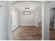 Dining room featuring a modern light fixture, wood floors, a window, neutral paint and white trim at 1147 Degraw Dr, Apopka, FL 32712