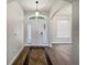 Inviting foyer with wood floors, sidelights, and transom window offering plenty of natural light at 1147 Degraw Dr, Apopka, FL 32712