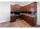 Well-equipped kitchen featuring stainless steel appliances, granite counters, and dark cabinetry at 1147 Degraw Dr, Apopka, FL 32712