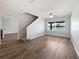 Bright living room featuring wood floors, a ceiling fan, and staircase to the upper level at 1147 Degraw Dr, Apopka, FL 32712