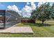 Landscaped backyard with spacious patio and screened enclosure at 19808 Seaview St, Orlando, FL 32833