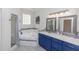 Elegant bathroom with blue vanity, soaking tub, and shower at 19808 Seaview St, Orlando, FL 32833