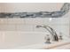 Close up of a modern bathroom faucet and tub at 19808 Seaview St, Orlando, FL 32833