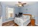 Well-lit bedroom with hardwood floors, a workspace and a queen bed at 19808 Seaview St, Orlando, FL 32833