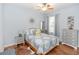 Cozy bedroom with hardwood floors, dresser, and natural light shining through the window at 19808 Seaview St, Orlando, FL 32833