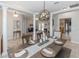 Elegant dining room with a modern chandelier, columns, and a view into the living areas at 19808 Seaview St, Orlando, FL 32833