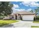 Charming single-story home with a well-manicured lawn and a two-car garage at 19808 Seaview St, Orlando, FL 32833